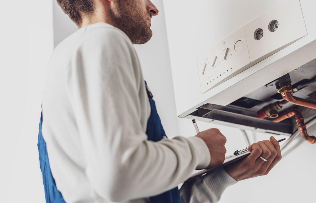 image of man observing tankless water heater
